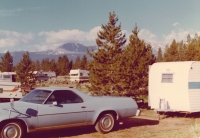 1975 Chevrolet El Camino in Colorado with 13 foot camper with matching blue stripe